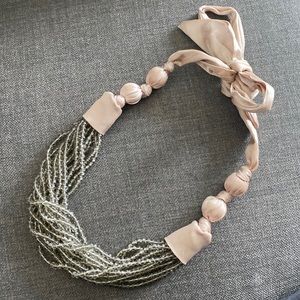 Anthropologie stranded bead necklace on satin ribbon closure.